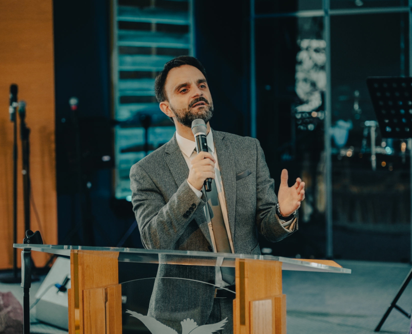 The President of the European Theological Seminary is explaining something from the pulpit