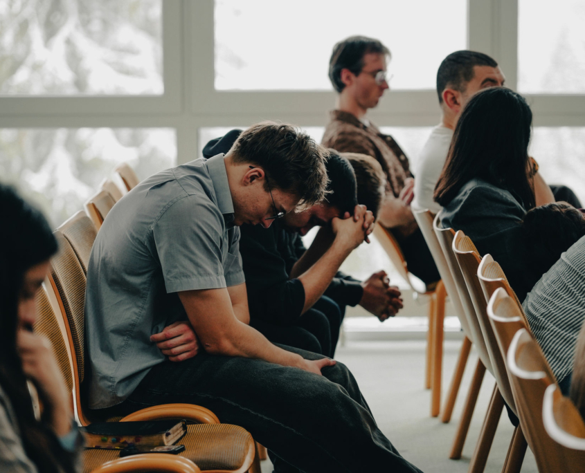 A couple of students are praying in their seats at the European Theological Seminary.