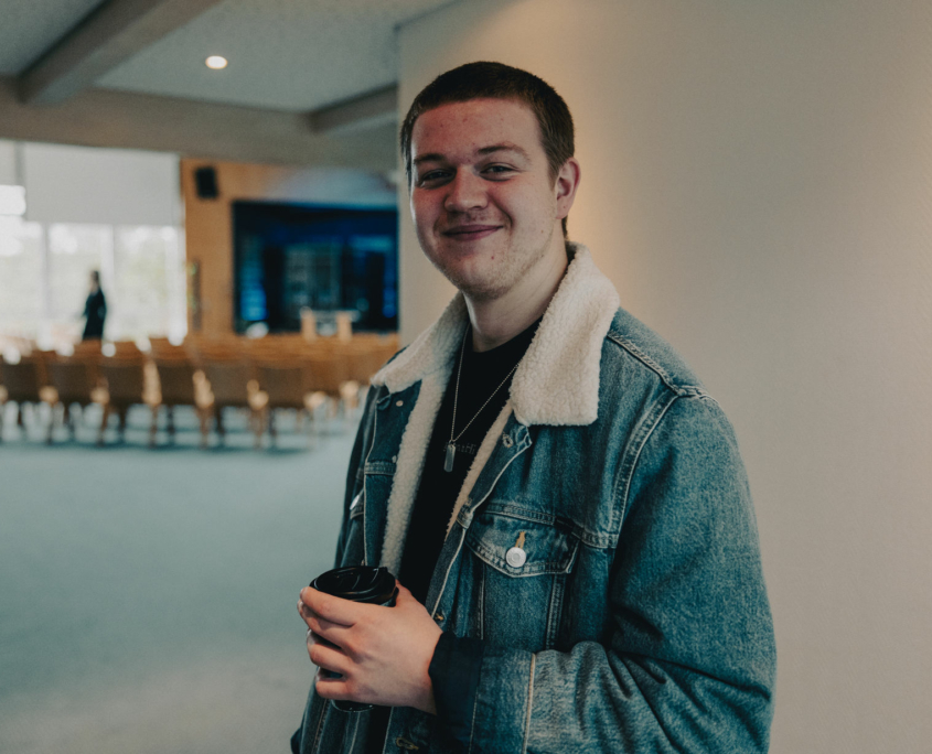 A student of the European Theological Seminary is smiling into the camera during the coffee break