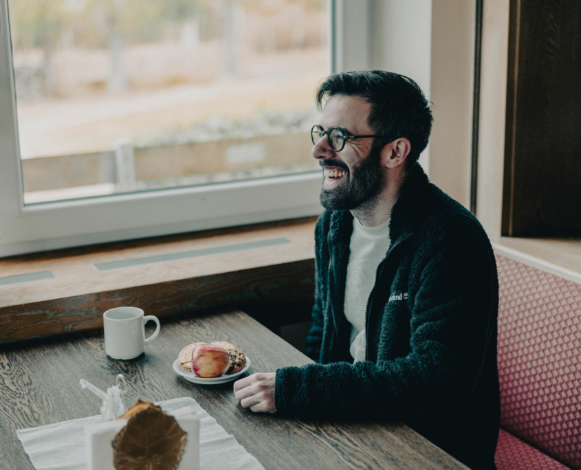 A happy student of the European Theological Seminary is smiling during the coffee break